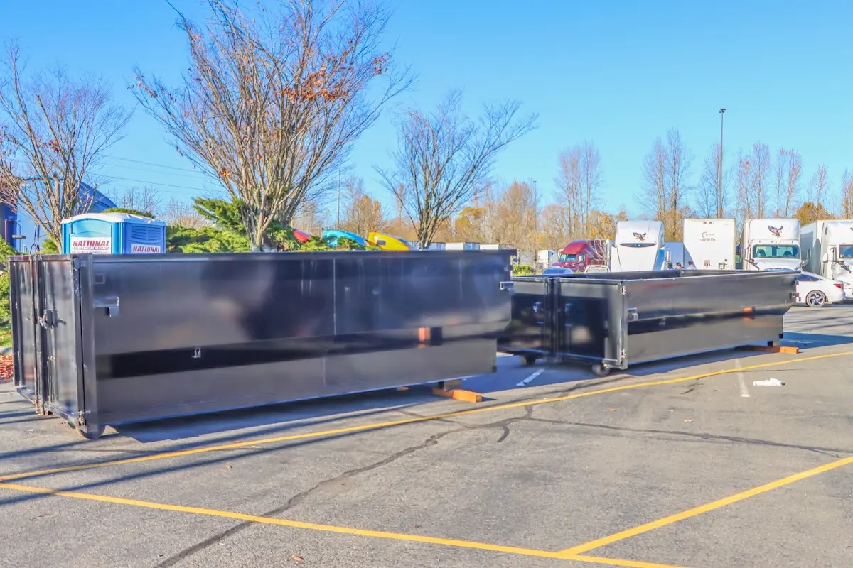 Professional dumpster rental service with roll-off container on residential driveway in Minneola